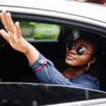Woman in a taxi getting someone's attention with her commanding presence
