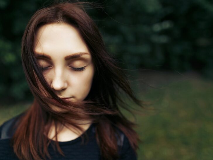 Woman with closed eyes feeling the wind